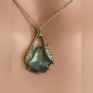 Alexis Bittar necklace w/ olive color stone in gold tone setting w/crystals.